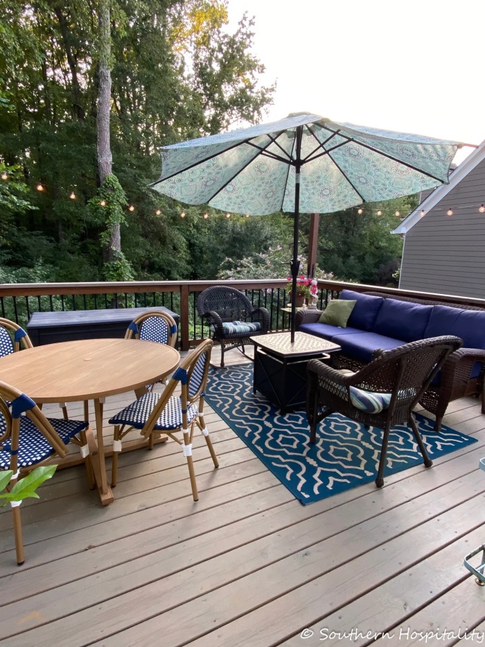 Summer porch with table, sofa and umbrella