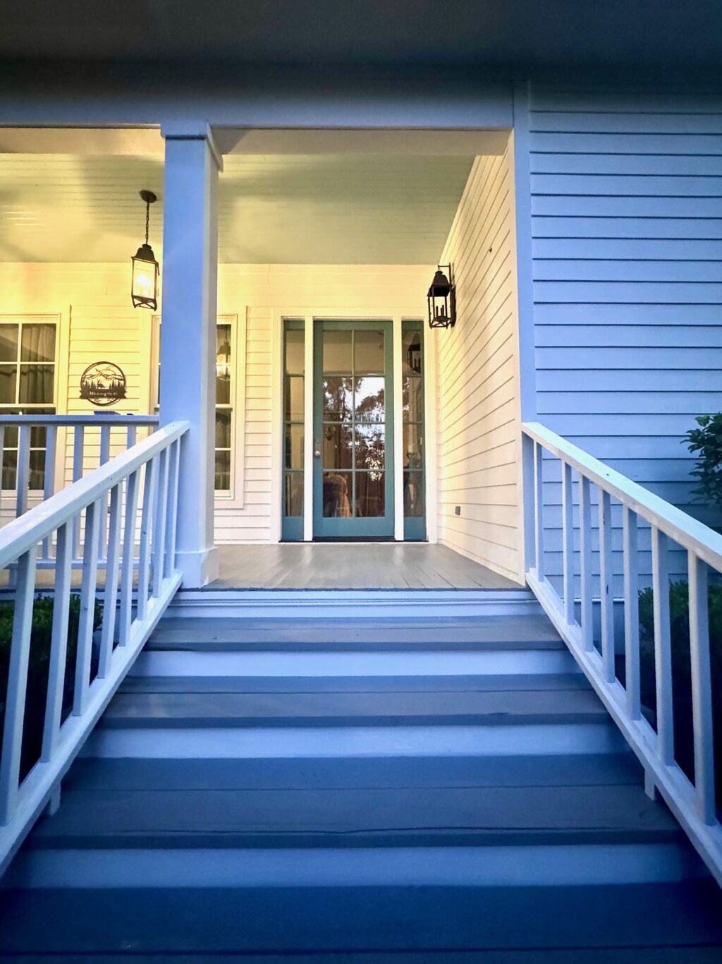 front porch with blue door and white trim