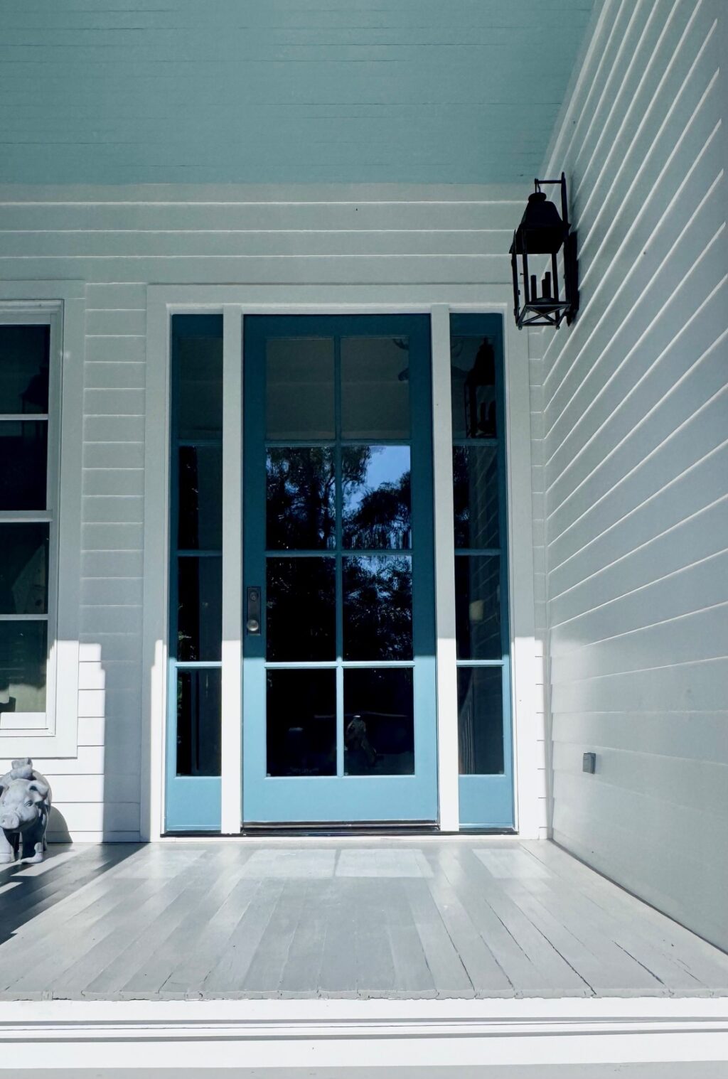 Blue door and side lights with white trim for contrast