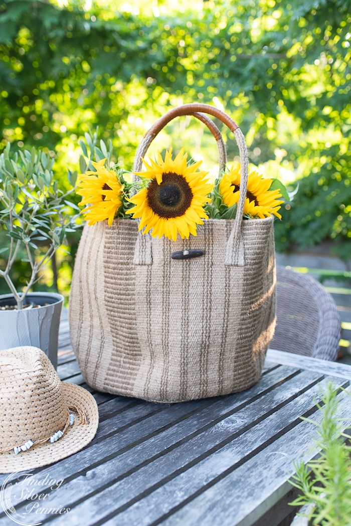 natural basket with sunflowers and hat