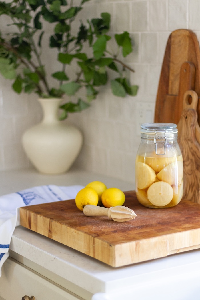 Summer home tour featuring layered decor, woven accents, and seasonal greenery