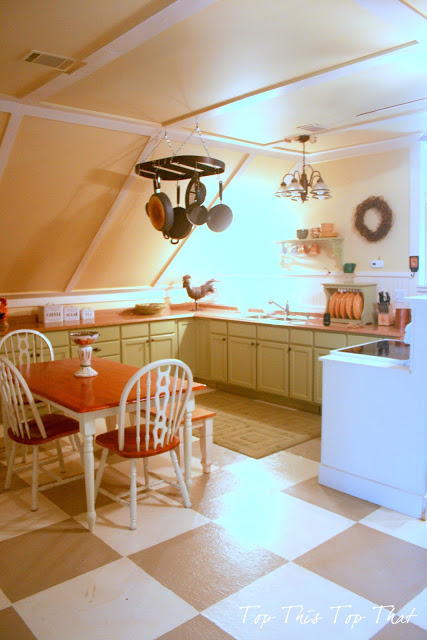 Early guest house kitchen featuring checkerboard floors and farmhouse table