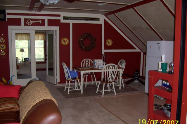 Guest house kitchen before remodel with red walls and country decor