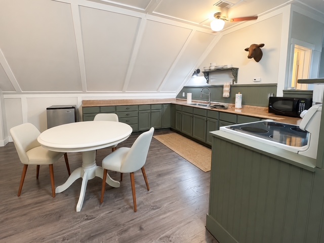 Cottage-inspired guest house kitchen with neutral decor
