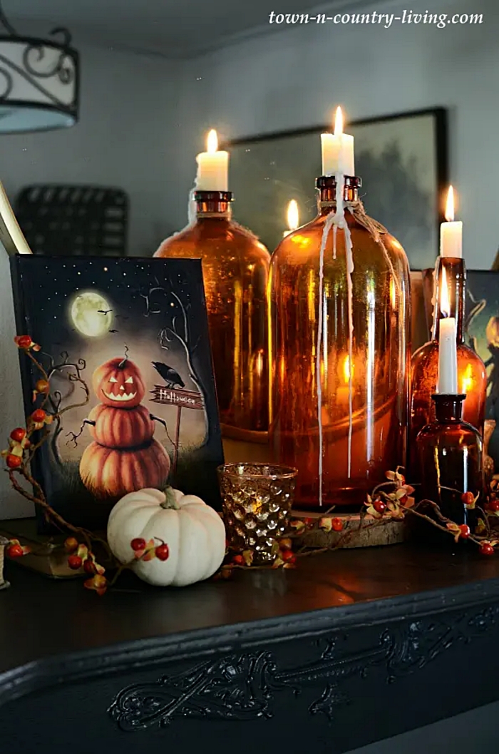 Spooky pumpkin Halloween printables displayed on a mantel