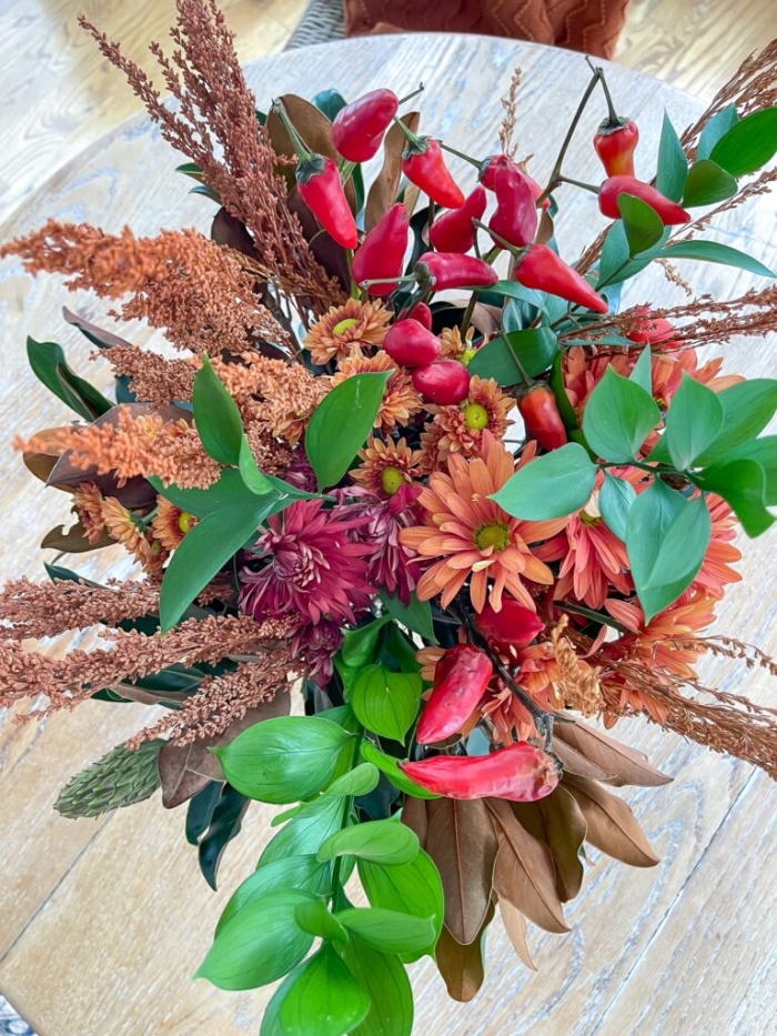Fall floral arrangement with magnolia leaves and dried floral stems